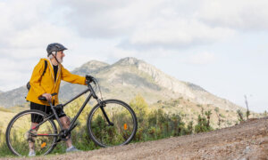 Man biking up a hill symbolizes safety and growth of GICs for Canadian retirees.