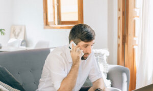 Canadian talking on a phone to a credit repair company