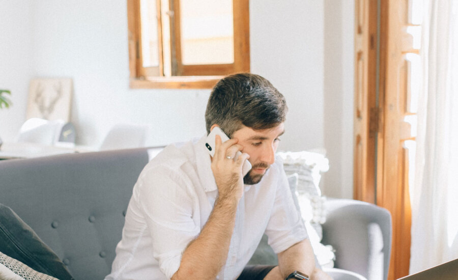 Canadian talking on a phone to a credit repair company