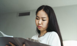 A woman is looking at her notice of assessment to determine her RRSP contribution room.