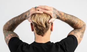 Rear view of young man wearing small hearing aids