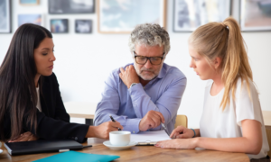 A father and adult daughter meet with a mortgage lender