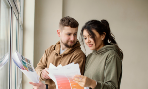 A man and woman consider paint chips in their new condo